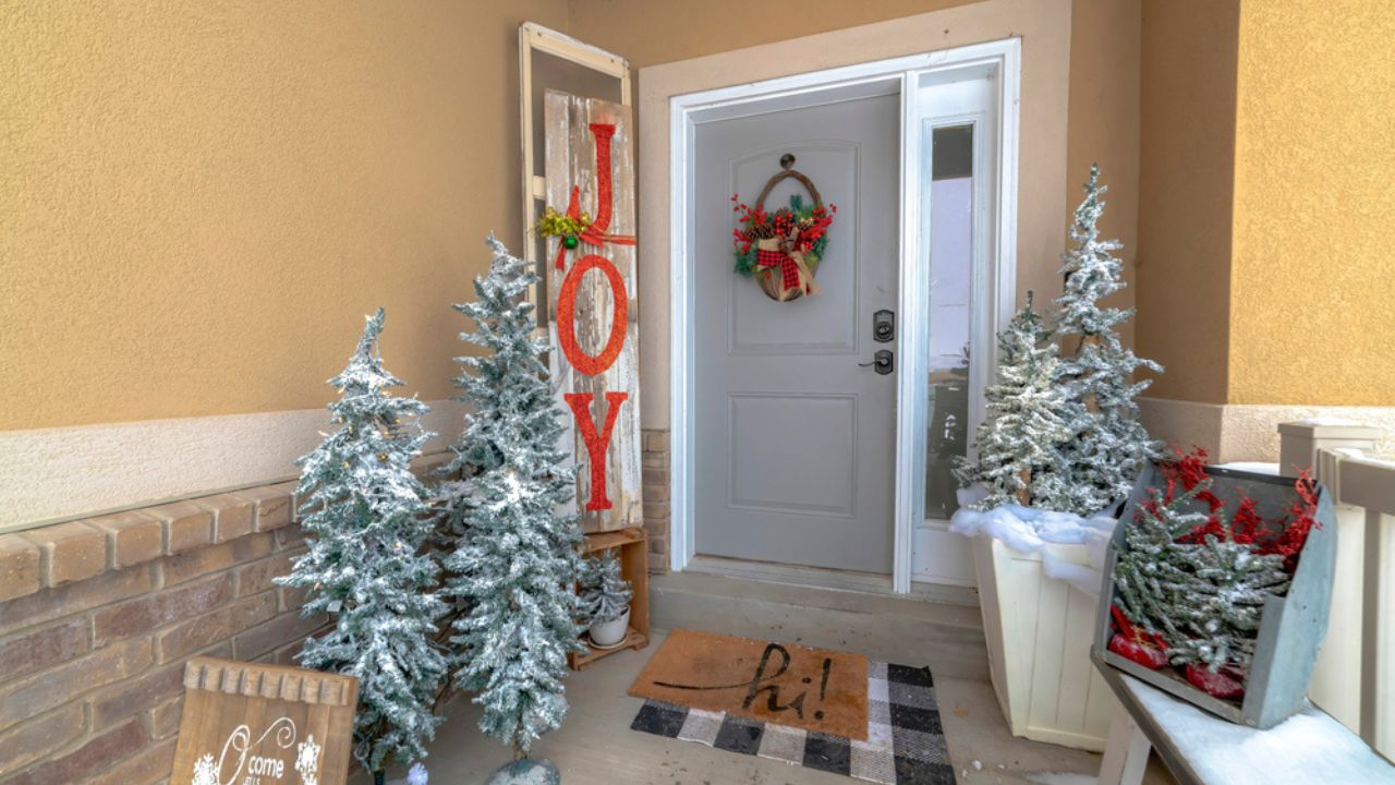 Panorama Festive home entrance with christmas trees holiday decorations and basket wreath