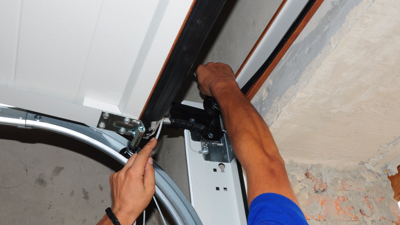 Repairman repair garage door opener. Garage door replacement, garage door repair. 