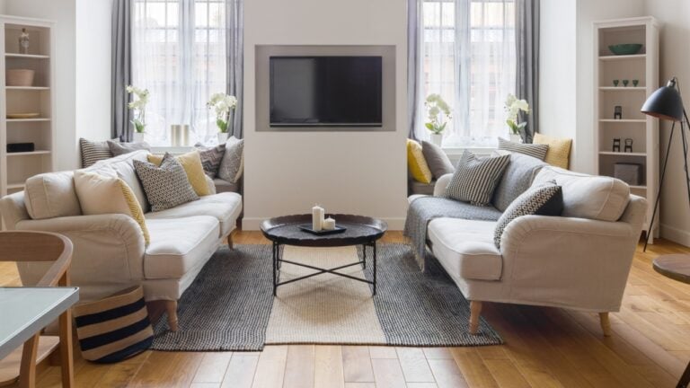 Panorama of modern living room with tv and two sofas