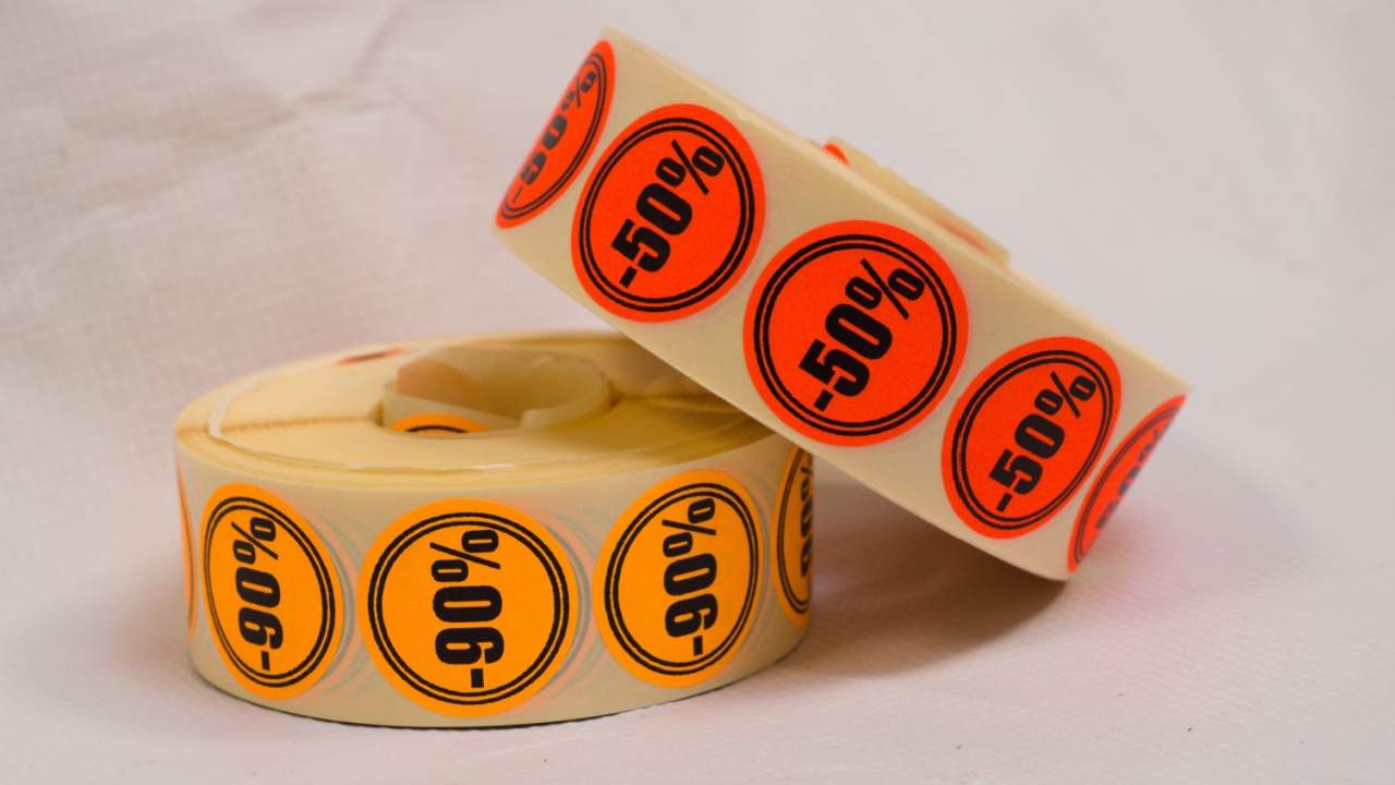 Discount sticker roll on gray background. Printed stickers. 