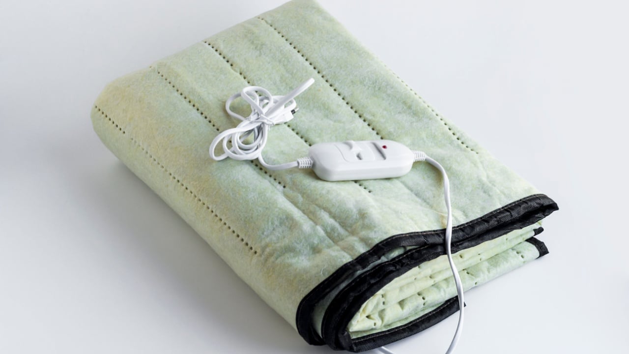 Double size,folded electric blanket on the white surface with copy space.Close up taken.