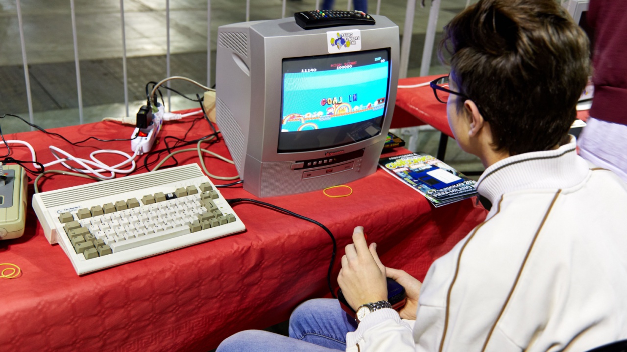 Milan, Italy - March 8 2019 Cartoomics Comic Con A visitor plays retro vintage games of Nintendo