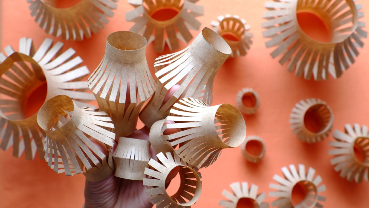 Close up woman hand hold six small lantern in hand and group of paper lanterns on orange background , popular ornamental for mid autumn season