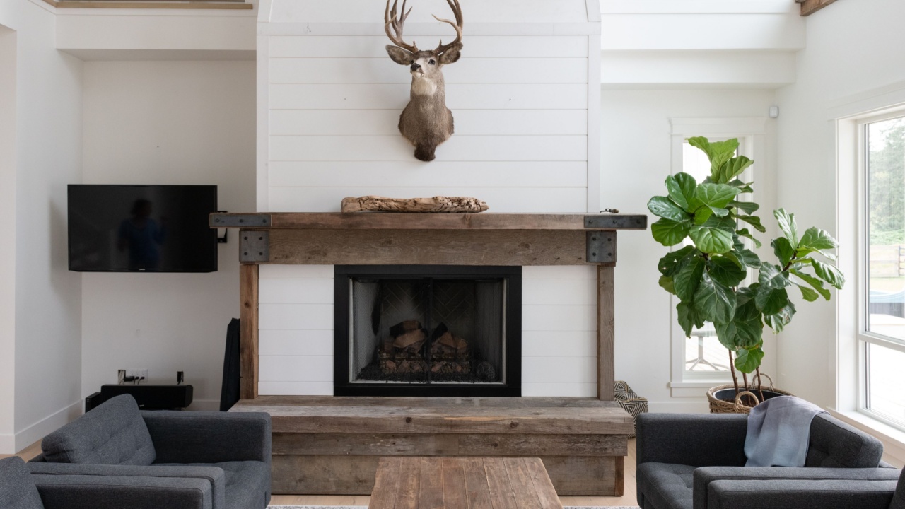 Brightly lit living room of a modern beach house or farmhouse. Featuring reclaimed wood and white walls.