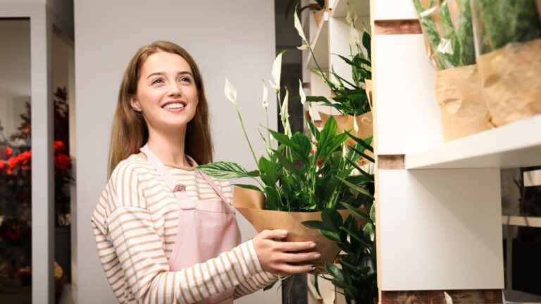 Professional female florist in apron at workplace