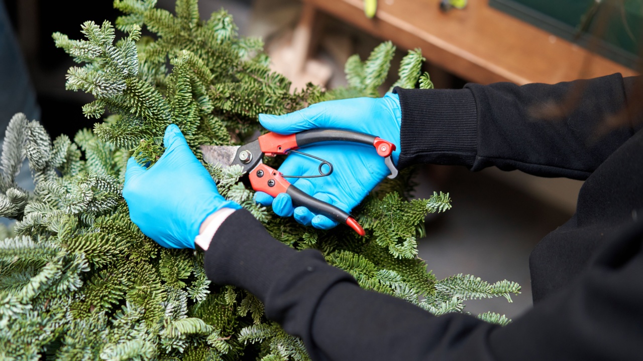 A woman decorates a Christmas arrangement. Master class on making decorative ornaments. Christmas decor with their own hands. The new year celebration. Flower shop