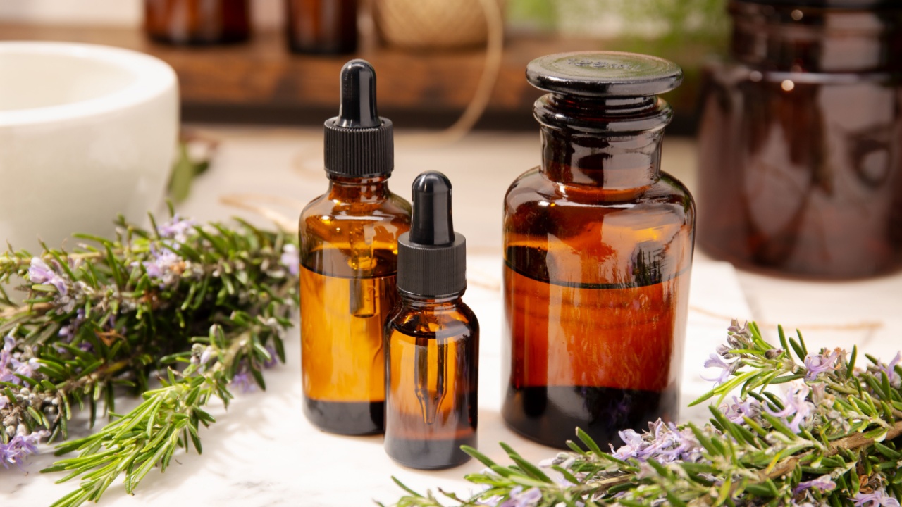 Herbal essential oil on vintage apothecary bottles. Alternative medicine, skin care, aromatherapy and natural medicine