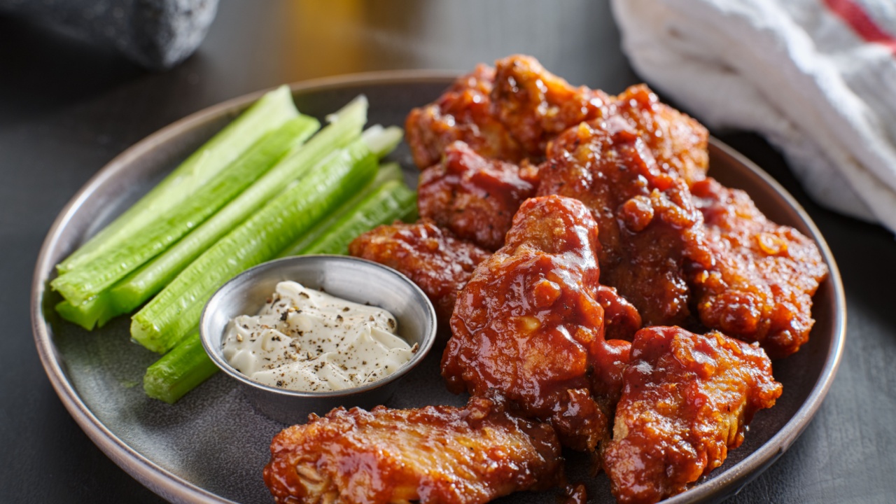 boneless chicken wings covered in honey garlic bbq sauce with ranch and celery