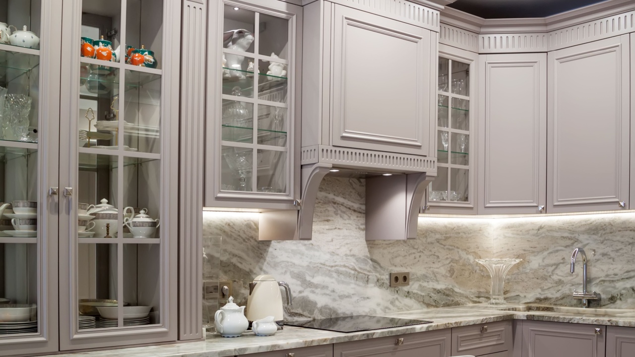 Modern beige and grey colored kitchen interior classic style with marble countertop in luxury apartment