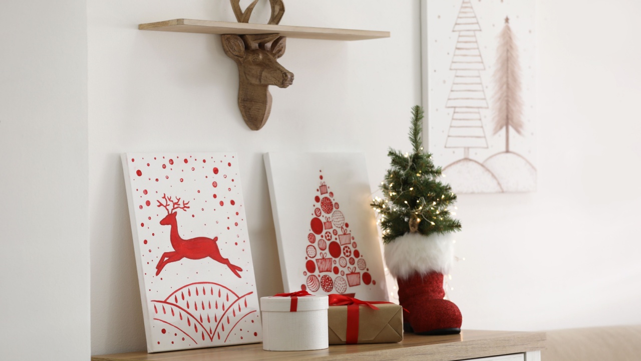 Beautiful Christmas pictures on chest of drawers indoors. Interior design