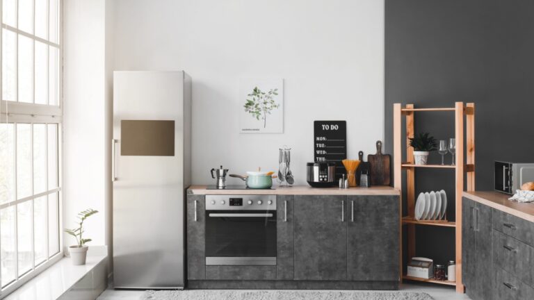 Interior of modern kitchen with refrigerator