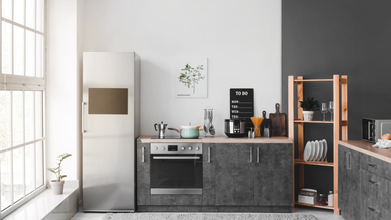 Interior of modern kitchen with refrigerator