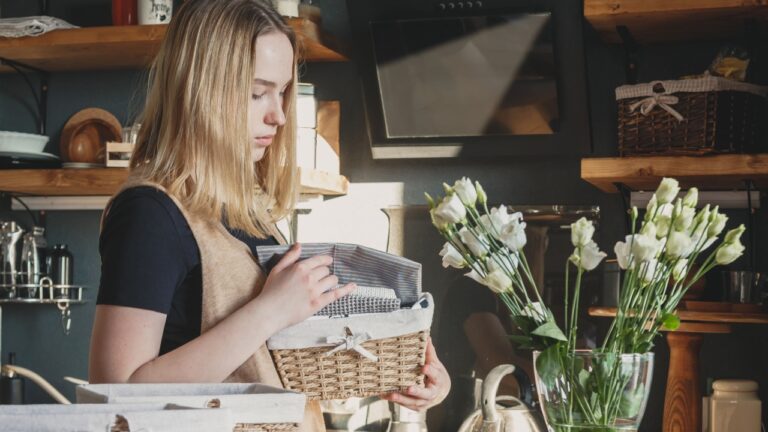 Girl spring cleaning in the kitchen. Piles kitchen towels in baskets. Spring cleaning, decluttering, cleaning space, cleaning agency