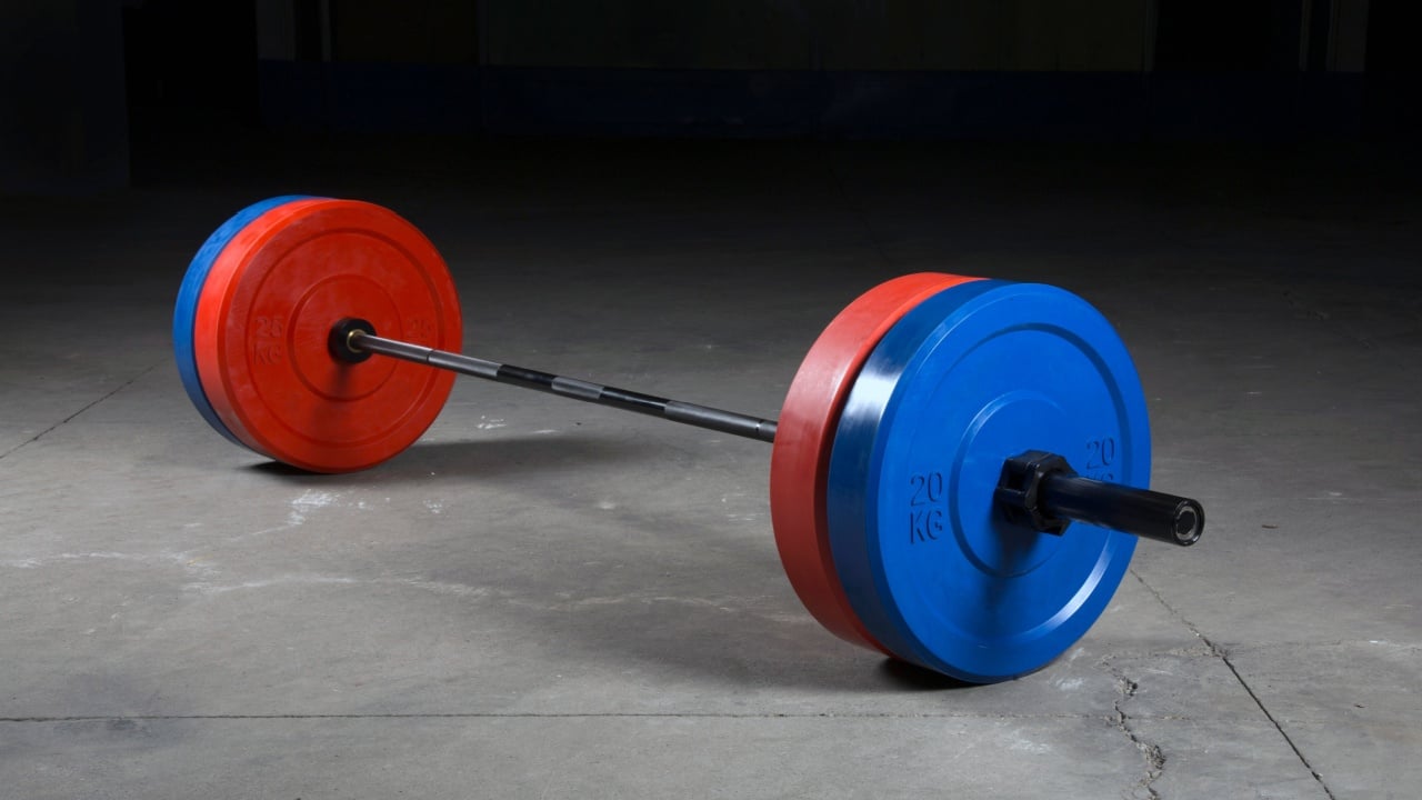 Barbell bar and barbell plate on black background