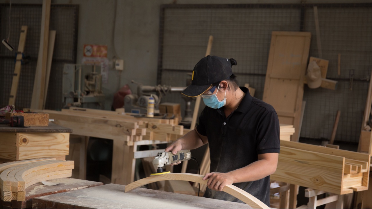 Photo of a young capenter doing his work in the worksh