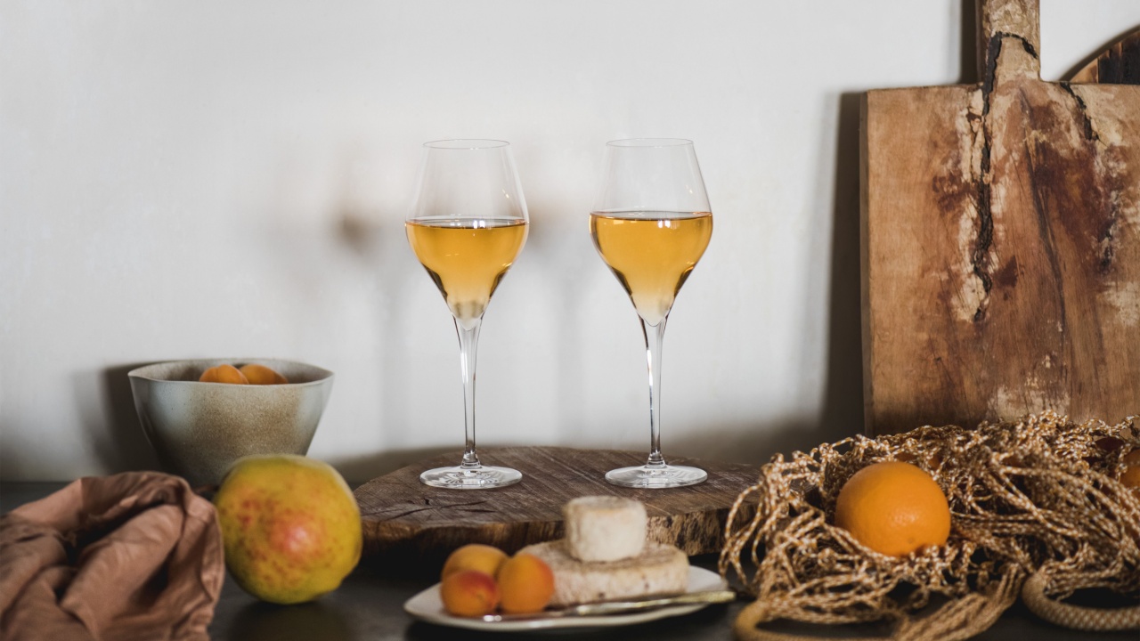 Orange or Amber wine in wineglasses, fresh fruits and appetizers