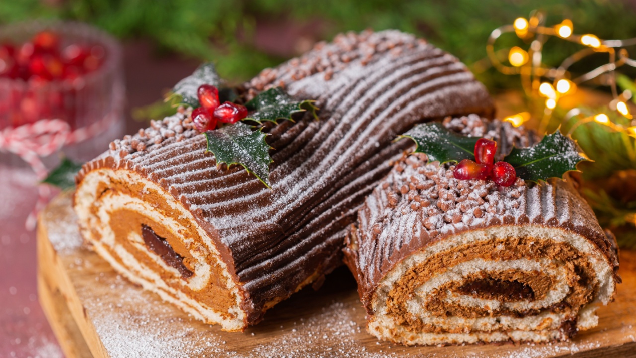 Traditional Christmas cake, chocolate Yule log with festive decorations
