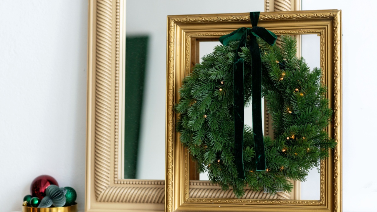 Christmas modern decor. The interior is decorated with Christmas wreaths and gold picture frames. New Year in a modern style. Soft selective focus.