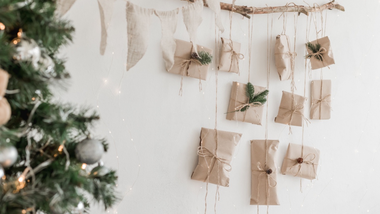 Christmas Advent calendar on the wall. Natural decoration. organic living. recycled paper and jute cord. selective focus. Christmas for kids ideas, DIY. White background, place for text