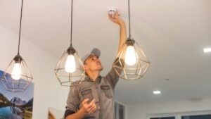 Handyman installing a smoke detector on the ceiling