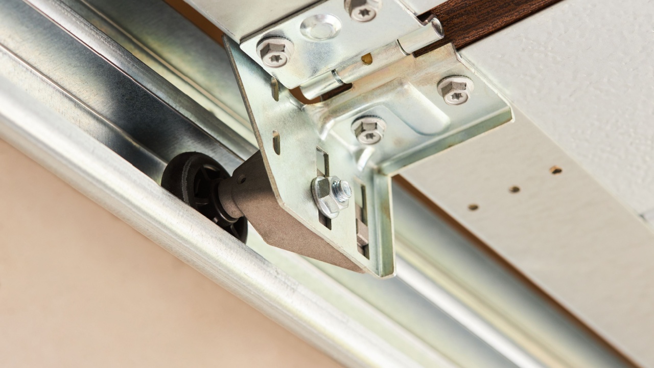 Automatic Garage Door mechanism close up. Lifting gates of the garage. Metal wheel, Springs tensioning, handle, fastening of a garage door. 