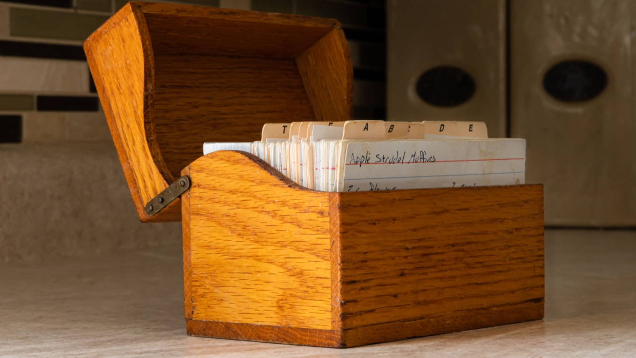 Wood recipe box on kitchen counter with hand written recipes