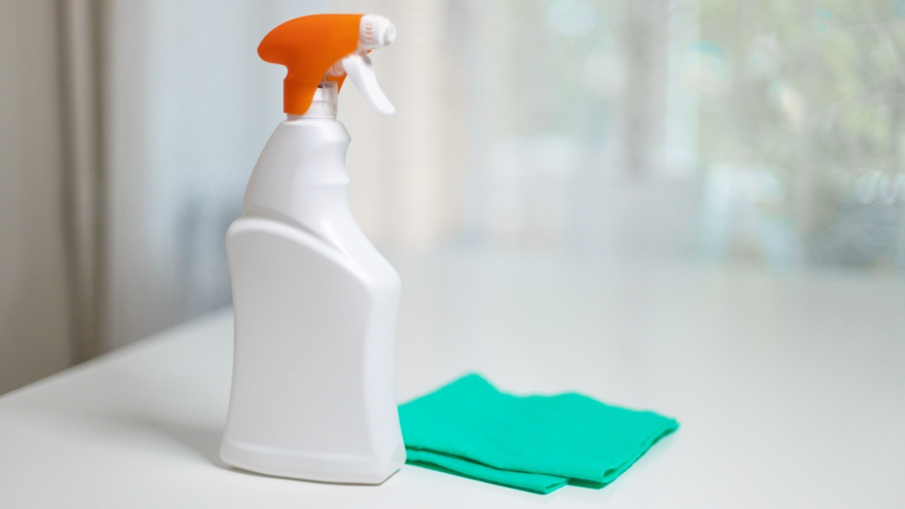 All purpose cleaner disinfectant spray bottle with towel on white wooden table at home or office Concept of disinfection and prevention of covid-19.