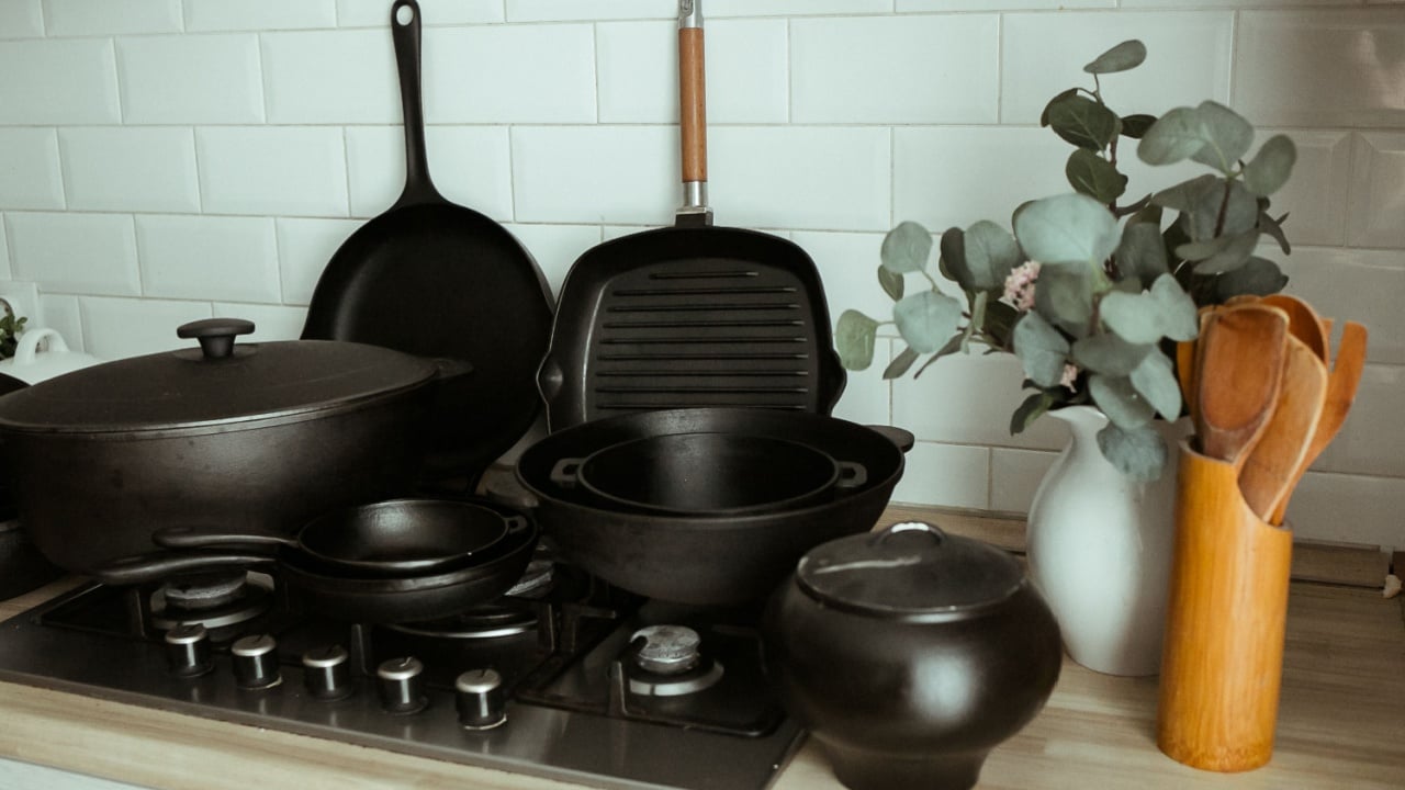 Composition from a set of cast-iron utensils. Cast iron for home use. Cooking in cast iron cookware.