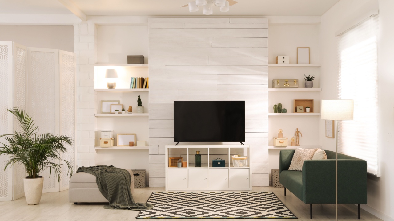 Cozy room interior with stylish furniture, decor and modern TV set