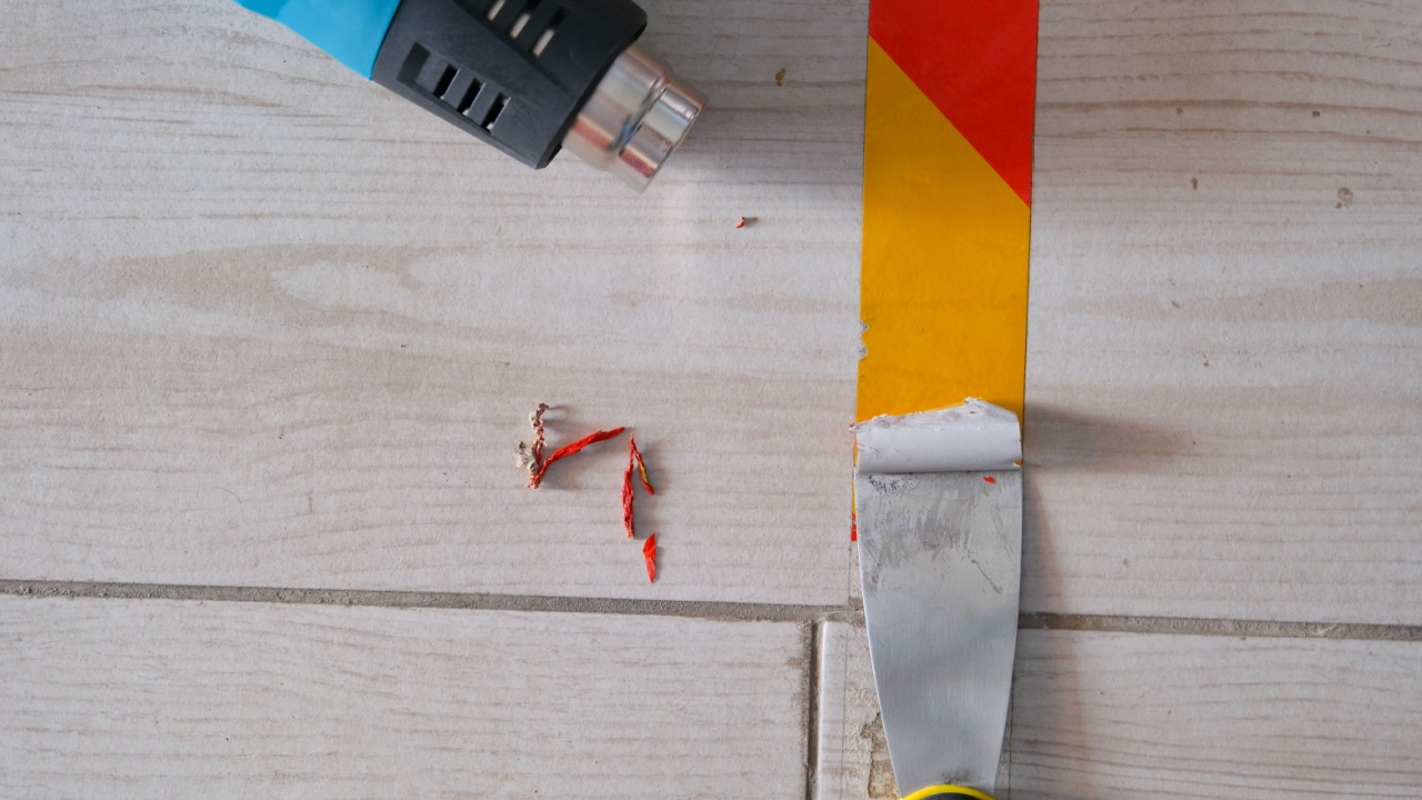 use of heat gun and spatula to remove marking tape from floor