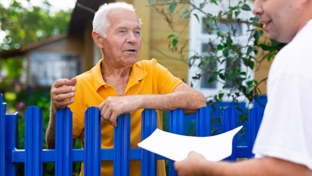 Senior man communicating with insurance company representative
