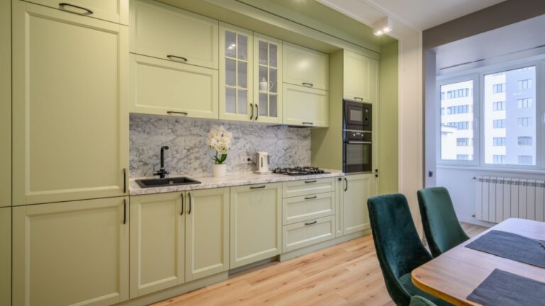 Modern light green luxurious kitchen with dining table