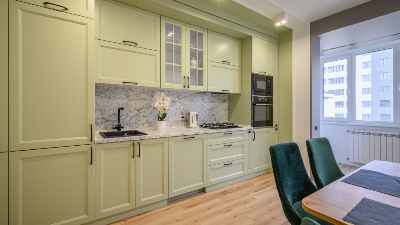 Modern light green luxurious kitchen with dining table