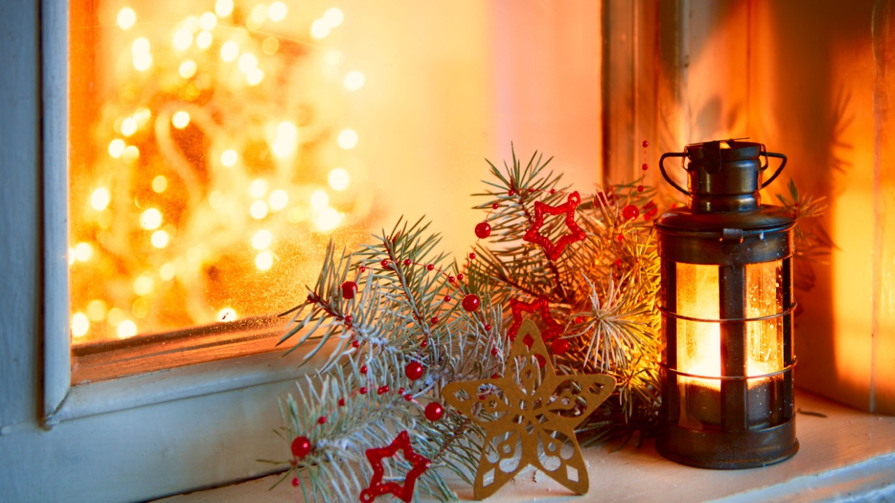 Christmas lantern in night on old window. 