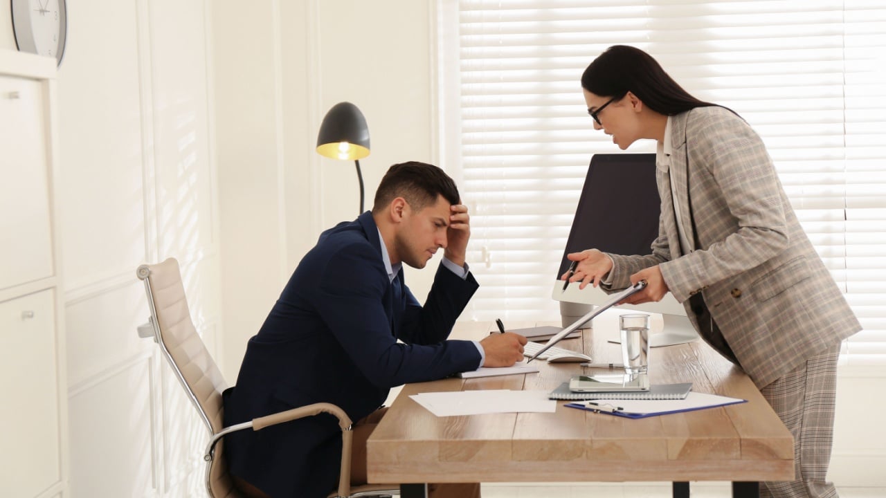 Boss screaming at employee in office. Toxic work environment