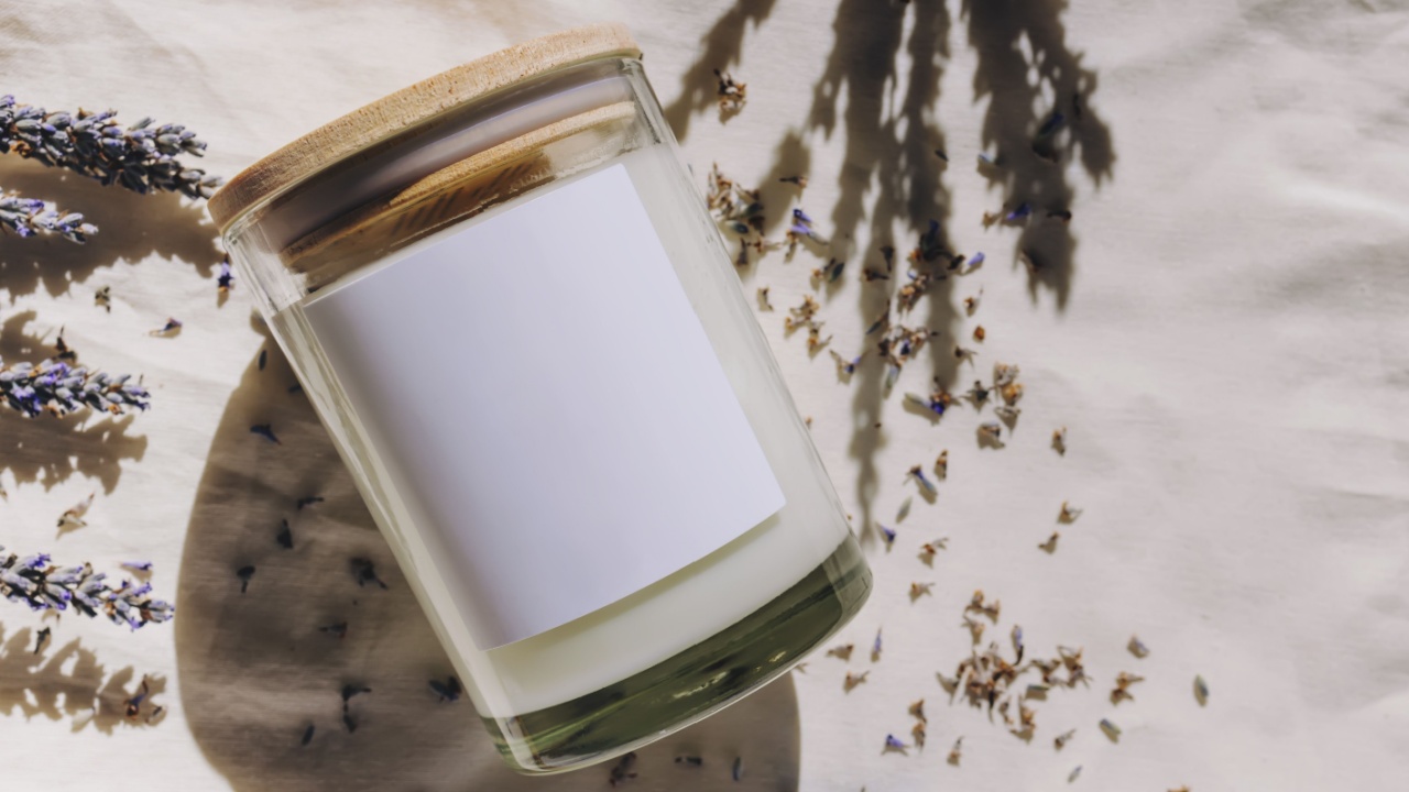 Candle label mock-up. Dry lavender and glass candle with empty label in natural sunlight