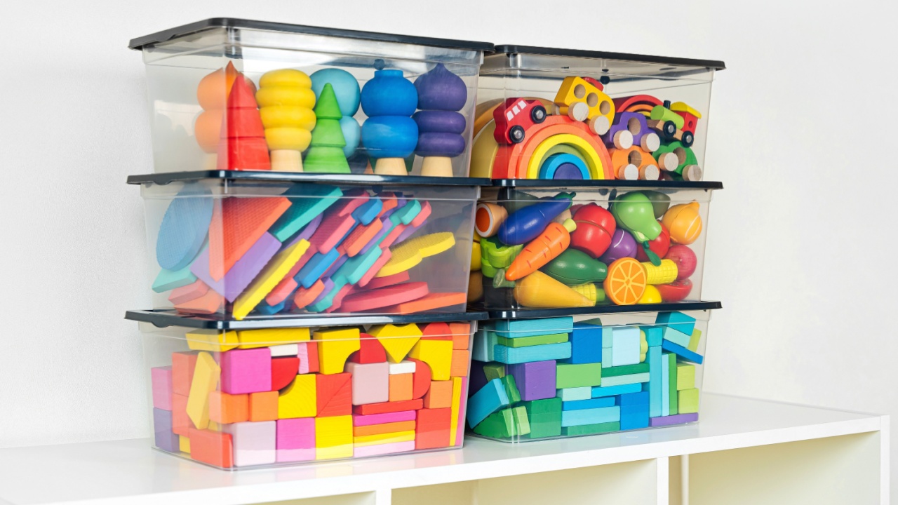 Transparent plastic containers with various children's toys on shelves. Organizing and Storage Ideas in nursery. Space organizing at childrens room. Toys sorting system.