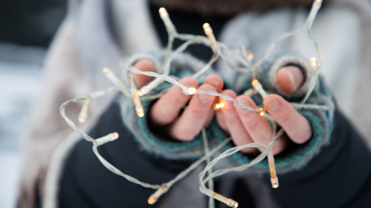 woman holding Christmas decoration in snow