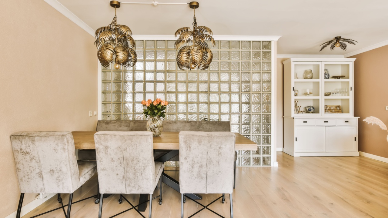a dining room with chairs and a chandel in the middle of the room that is made out of glass blocks