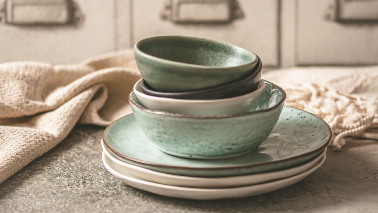 Gray stoneware plates and bowls on a rustic table