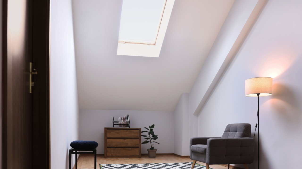 Attic room interior with slanted ceiling and furniture