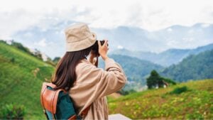 Young woman traveler taking a beautiful landscape at the mountains, Travel lifestyle concept
