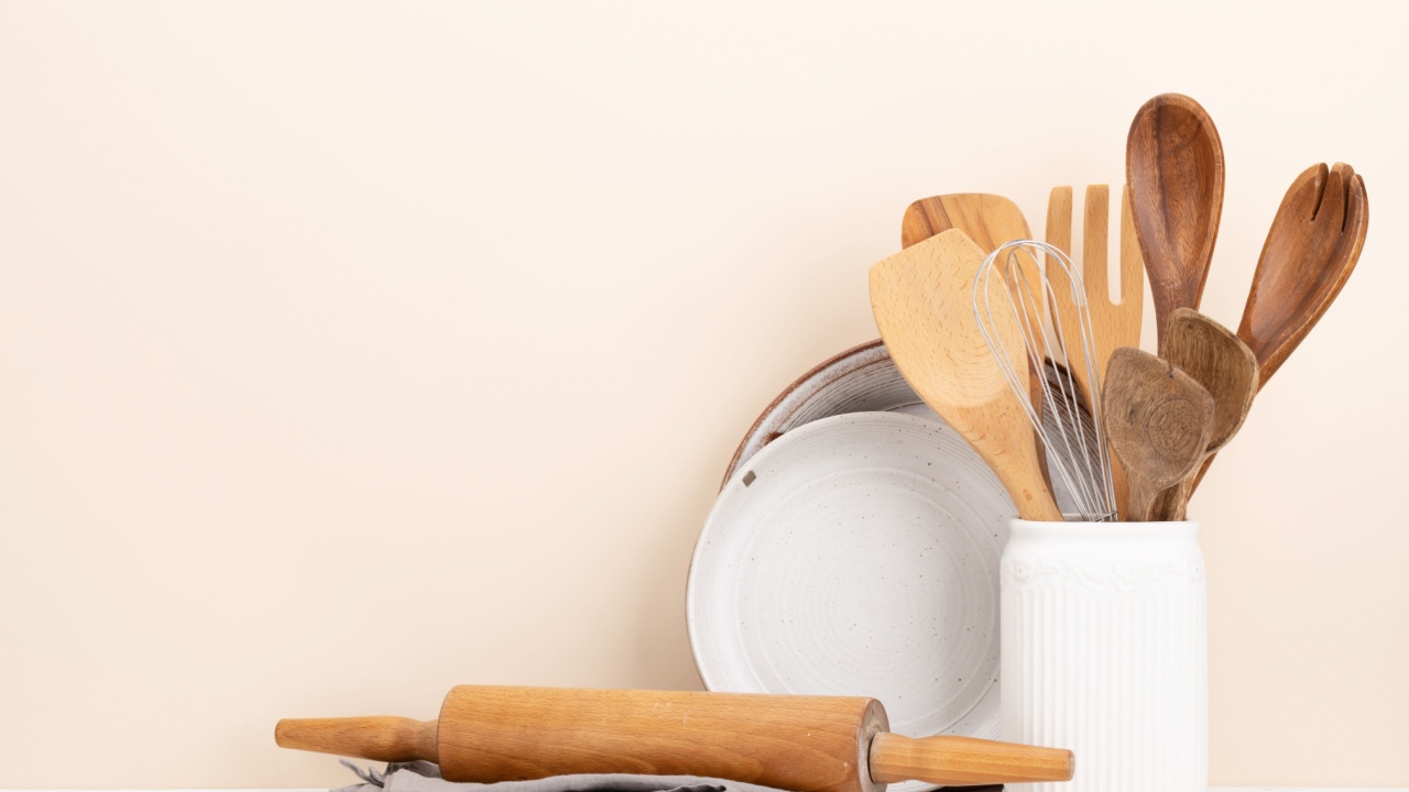 Kitchen utensils on wooden table. Front view with copy space
