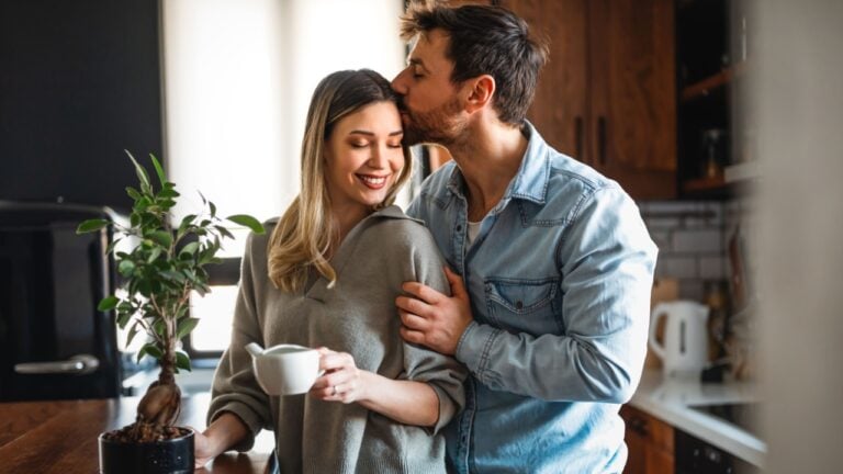 Loving everything about her. Smiling environmentally friendly couple with houseplant