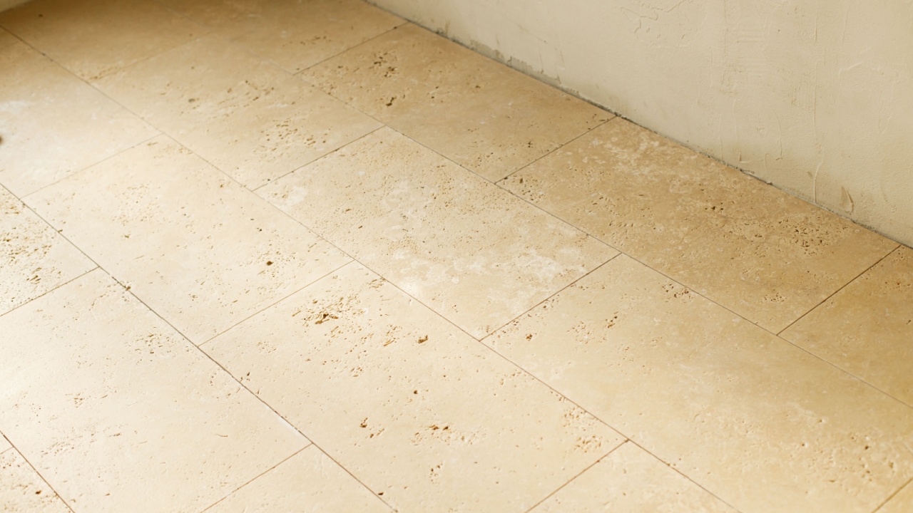 Travertine tiles masonry on floor in bathroom. Construction of house and home renovation concept. Stylish natural travertine stone tile close up