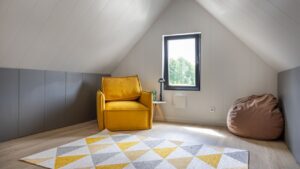 organization of the attic space with a bright yellow armchair, pouffe and carpet
