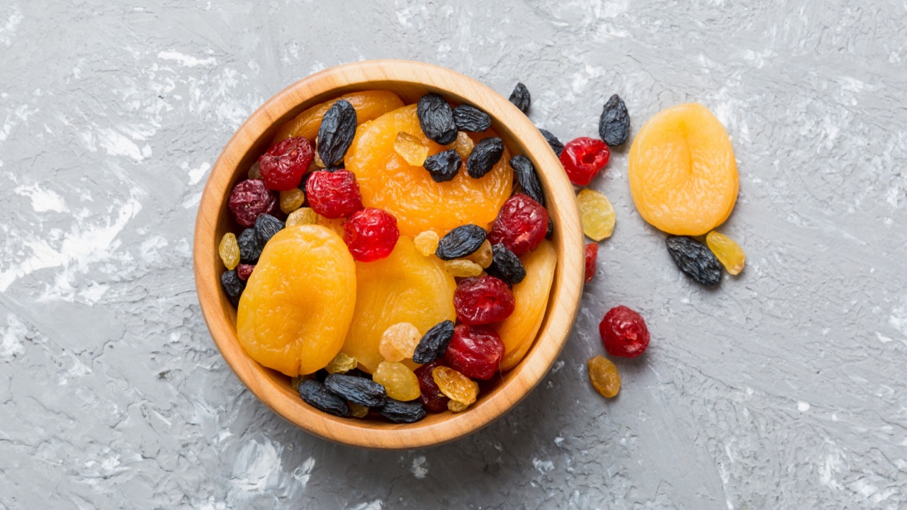 Bowl with different dried fruits on table background, top view. Healthy lifestyle with copy space.