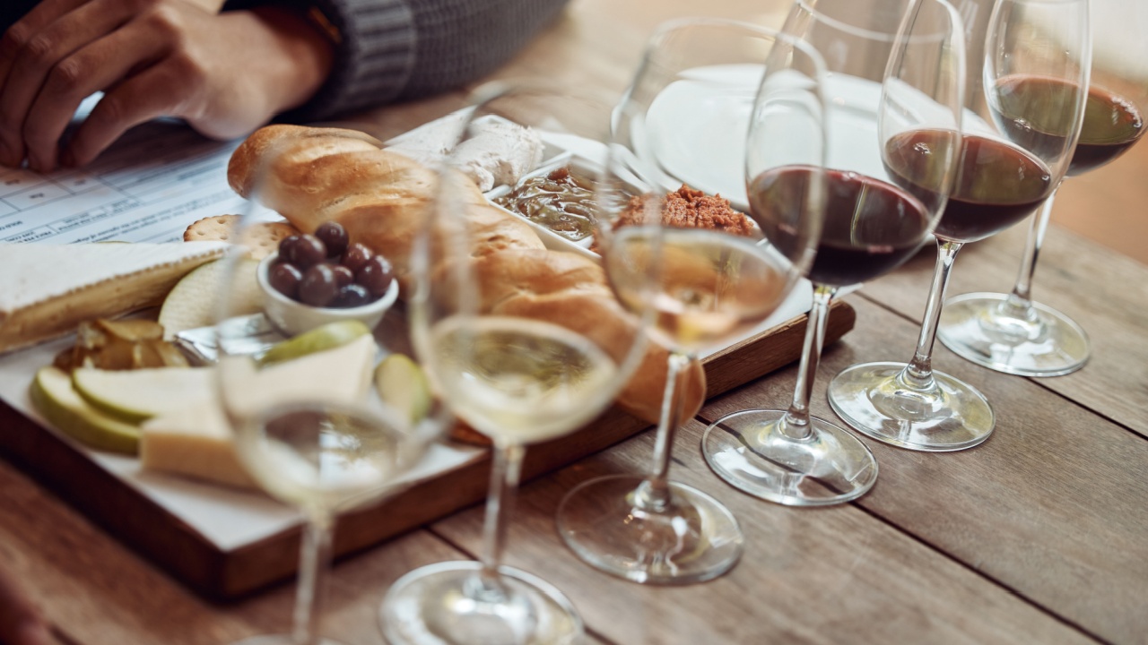 Wine tasting, cheese board and winery restaurant with alcohol and glass for customer. Eating, drink and person with rich wines and food pairing in a fine dining and luxury snack experience alone
