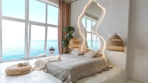 the interior of the bedroom in Balinese style by a large window with an awesome view of the sea. behind the bed is a curved mirror with LED illumination