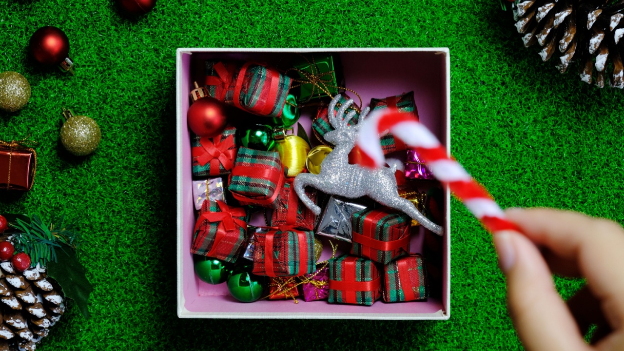 woman hand holding christmas decoration holidays and people concept